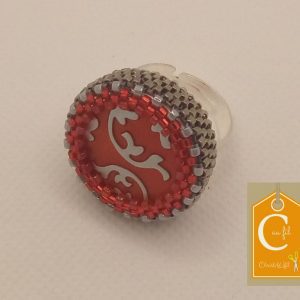 Bague rouge avec volutes argentées